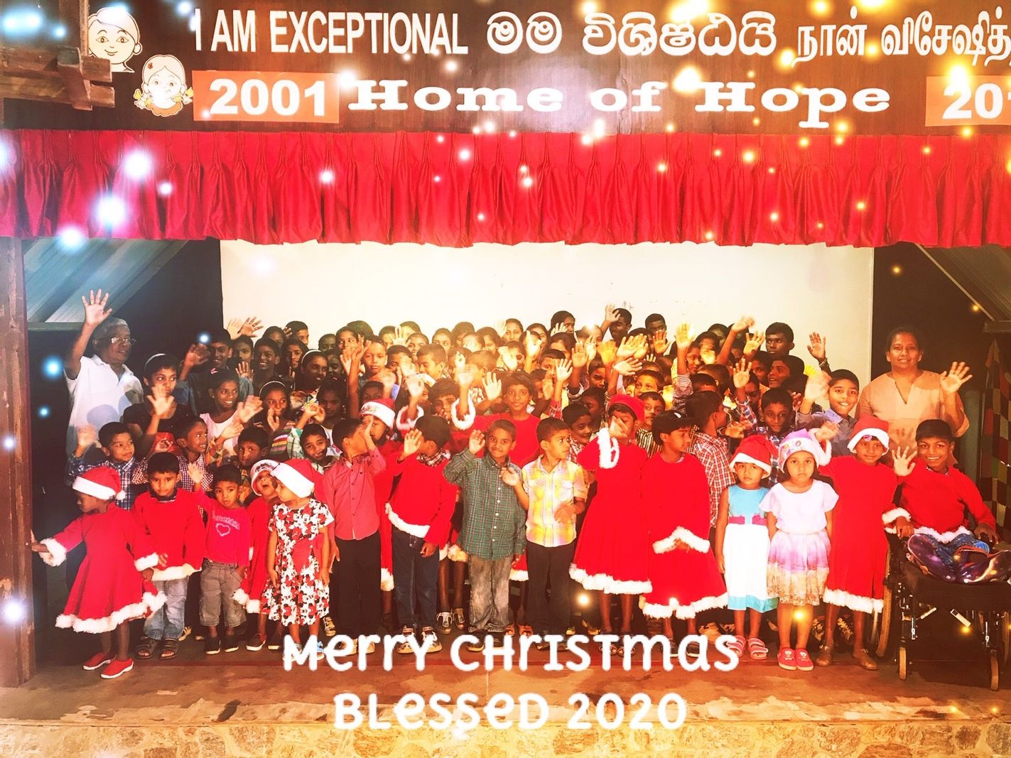 Home of Hope children in Santa outfits on stage under the words Merry Christmas 2020