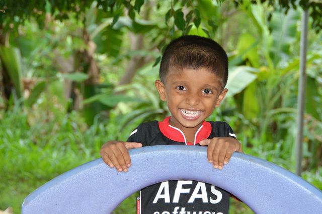 Smiling boy at a piece of play equipment